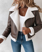  faux leather shearling-trimmed thermal biker jacket, white ribbed top, blue jeans.