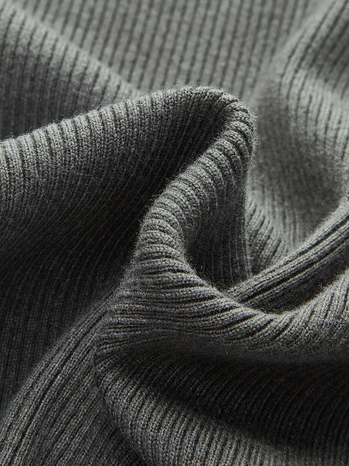 Classic Knitted Cardigan in dark gray ribbed fabric, vertical lines, cozy buttoned layering.