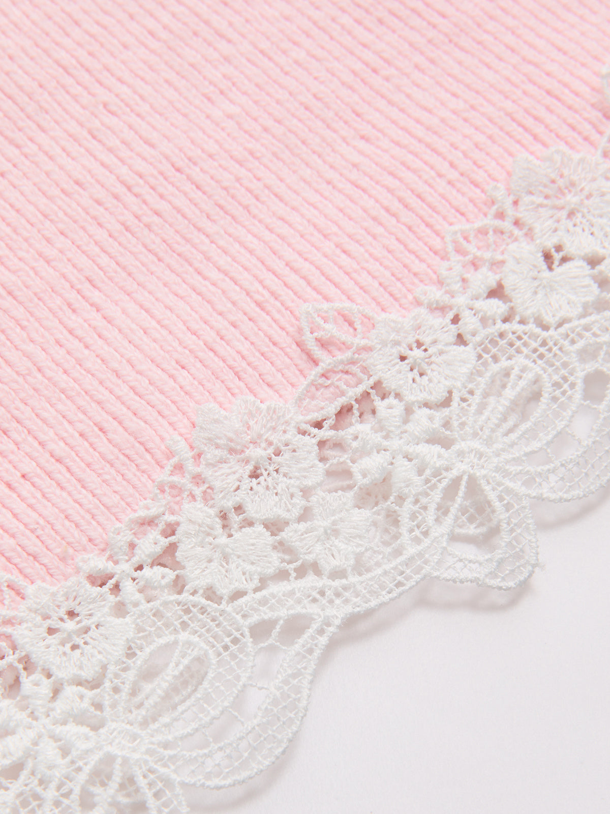 A pink short sleeve ribbed cardigan with white lace trim and refined knit texture.
